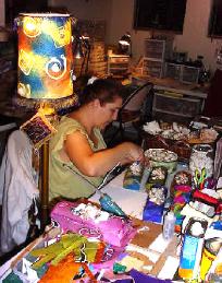 Mary creatiing handmade paper boxes for one of her wholesale customer.